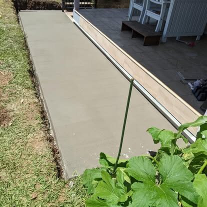A tidy concrete path running along the side of a house